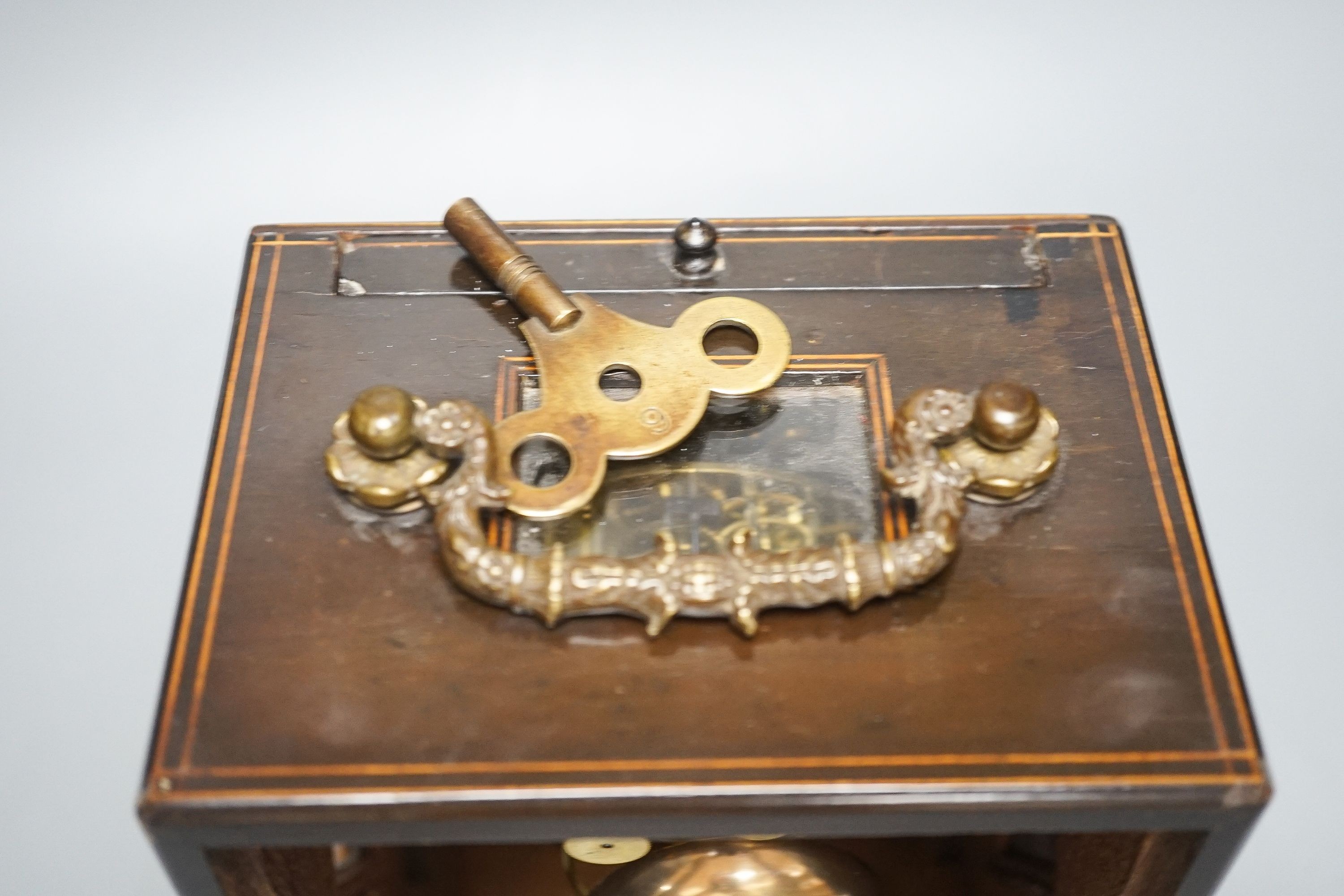 A 19th century French mahogany cased mantel clock, key and pendulum
